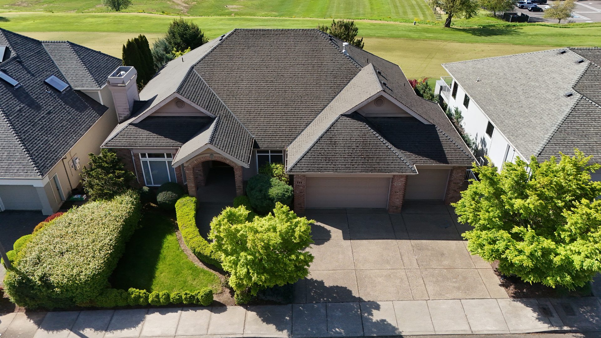 Aerial view of 744 Creekside Drive SE — front of home with the 12th fairway behind
